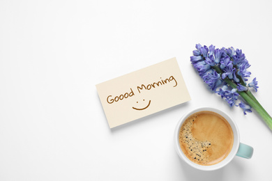 Card with Good Morning wish, coffee and hyacinth flowers on white background, top view