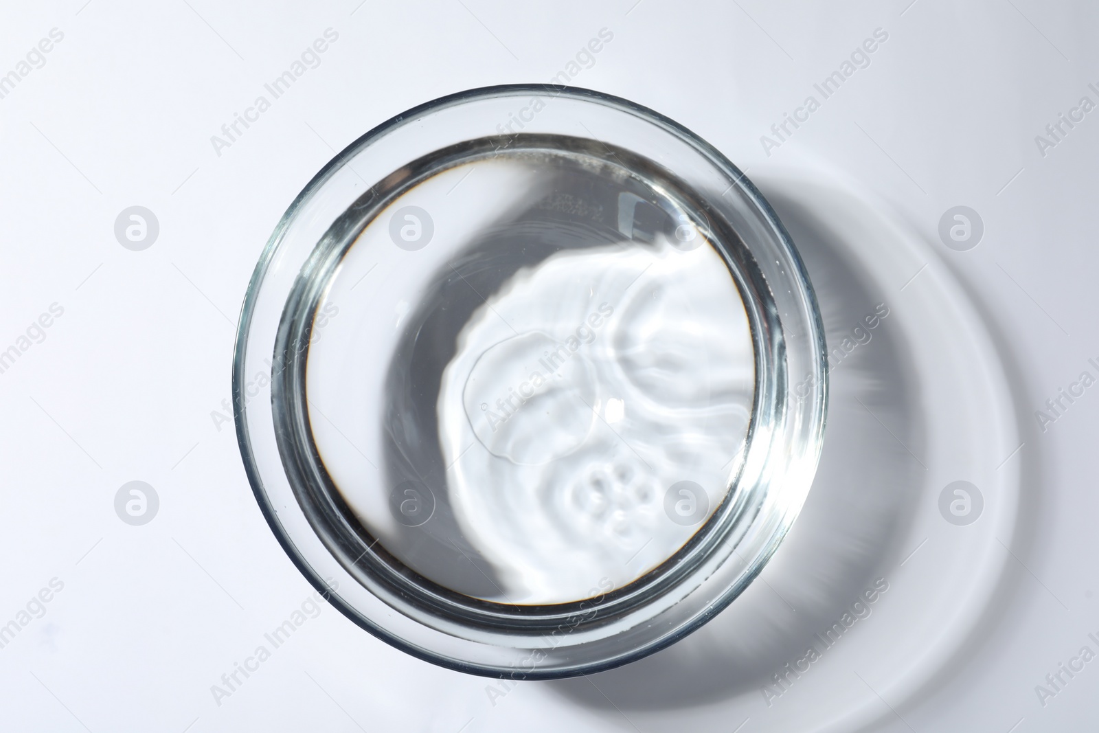 Photo of Glass bowl with water on white background, top view