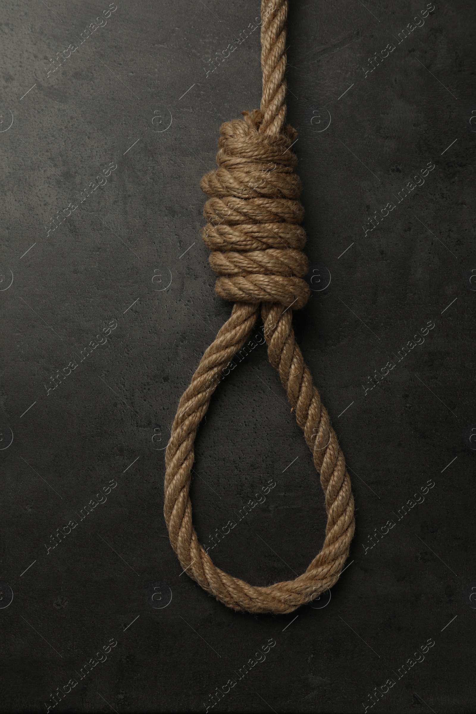 Photo of Rope noose with knot on grey table, top view