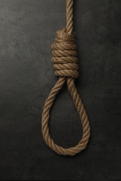 Rope noose with knot on grey table, top view