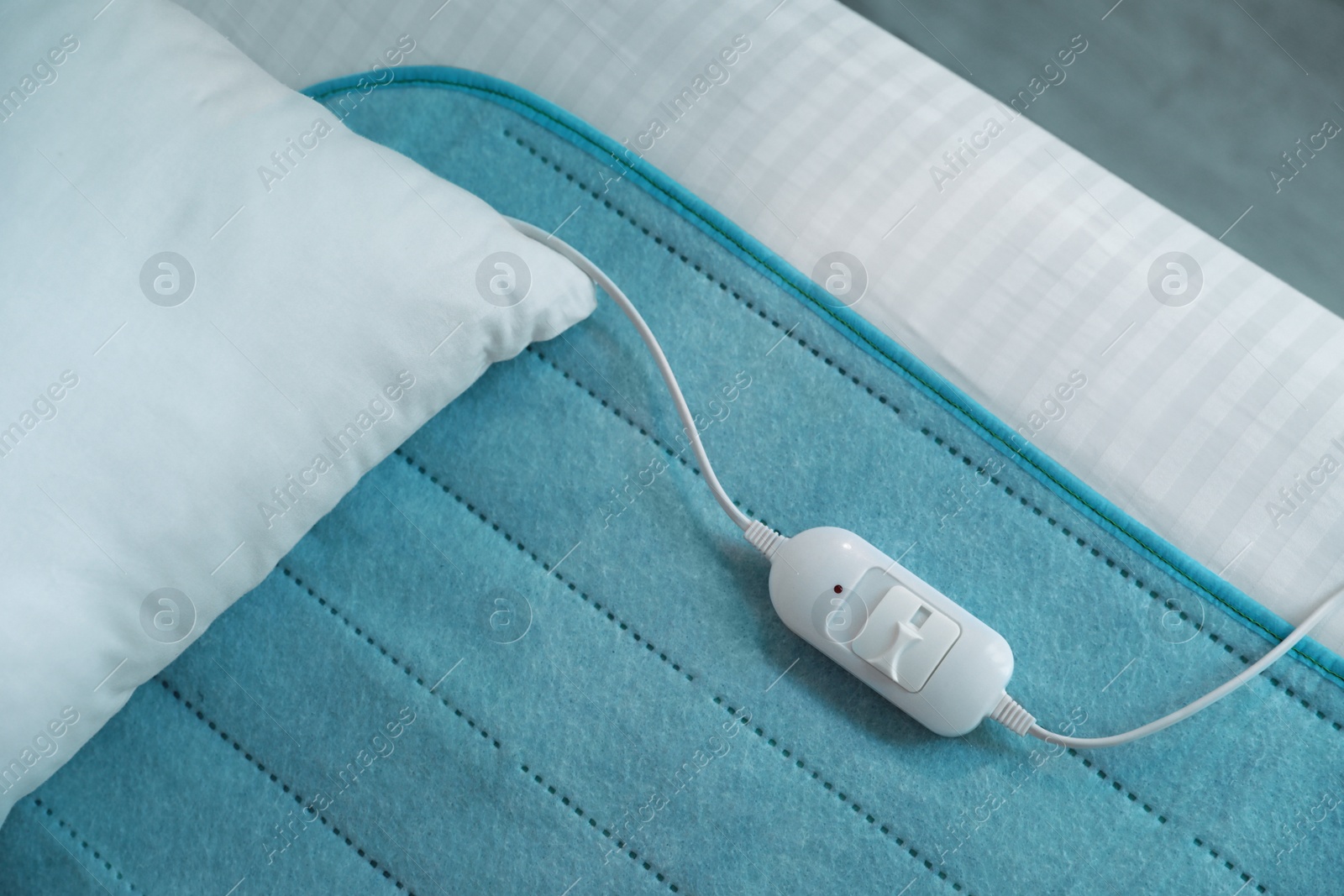 Photo of Bed with electric heating pad, top view