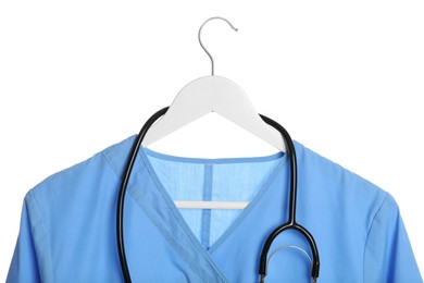 Photo of Light blue medical uniform and stethoscope on white background