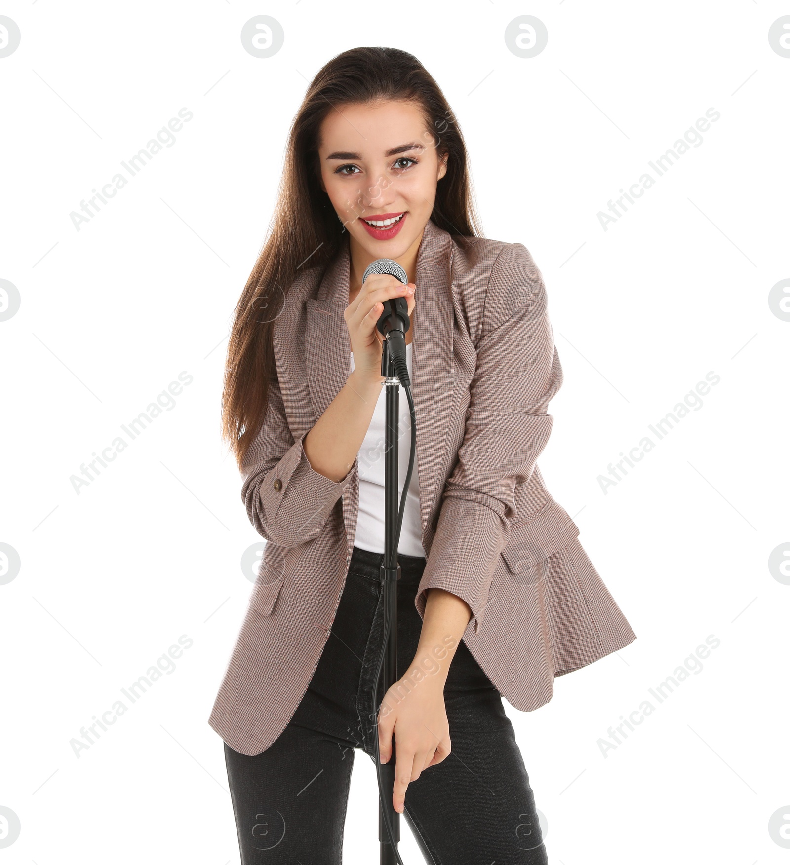 Photo of Young stylish woman in jacket posing with microphone on white background