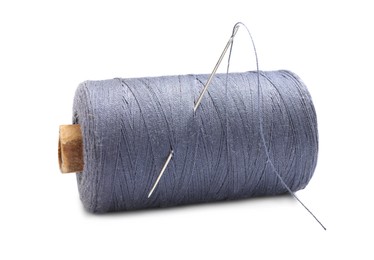 Grey sewing thread with needle on white background