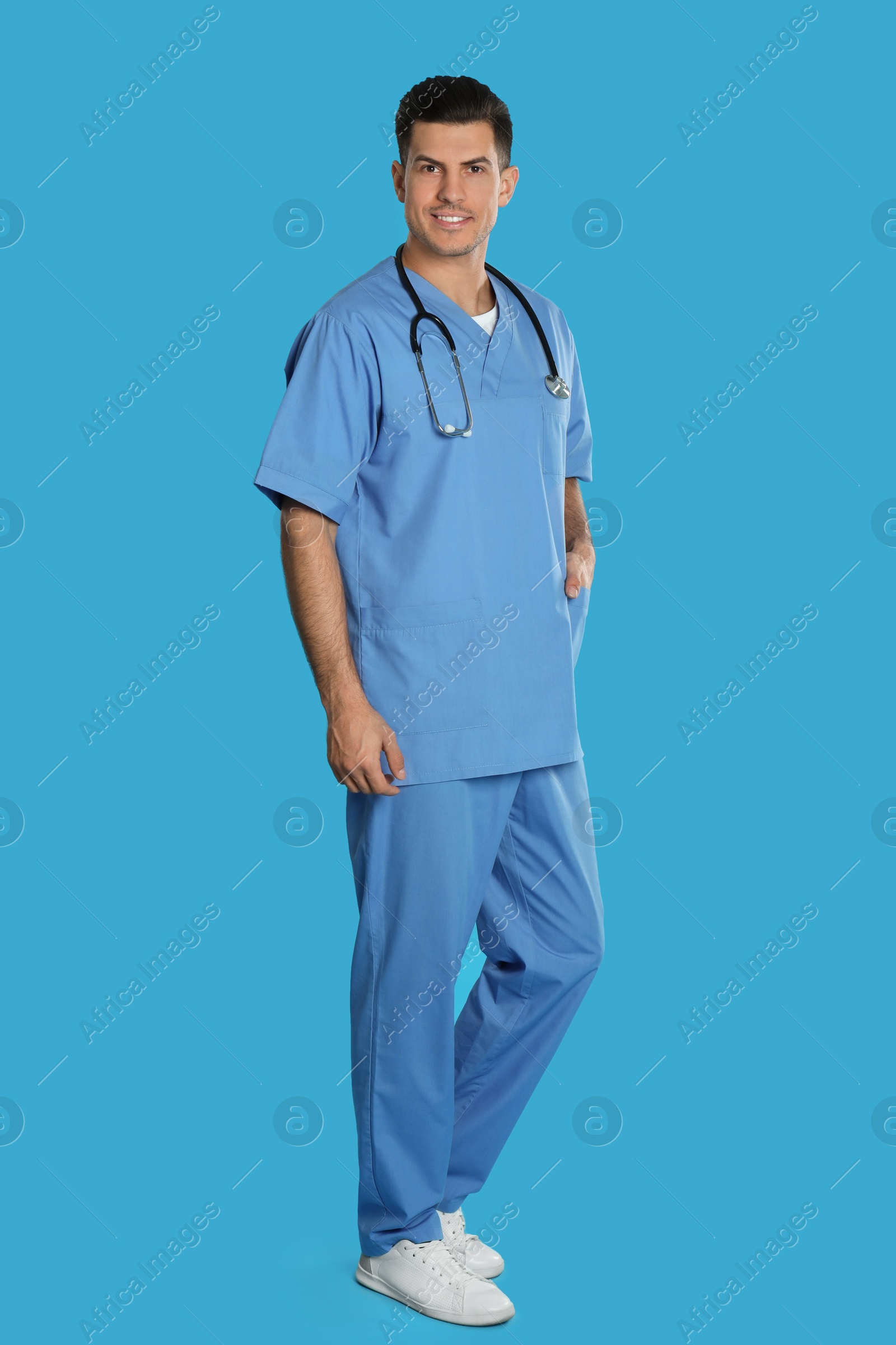 Photo of Portrait of doctor with stethoscope on blue background