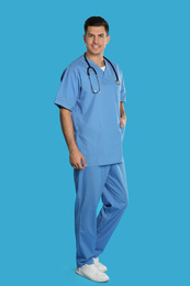 Photo of Portrait of doctor with stethoscope on blue background