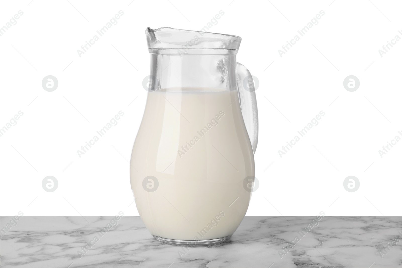 Photo of One jug of tasty milk on marble table against white background