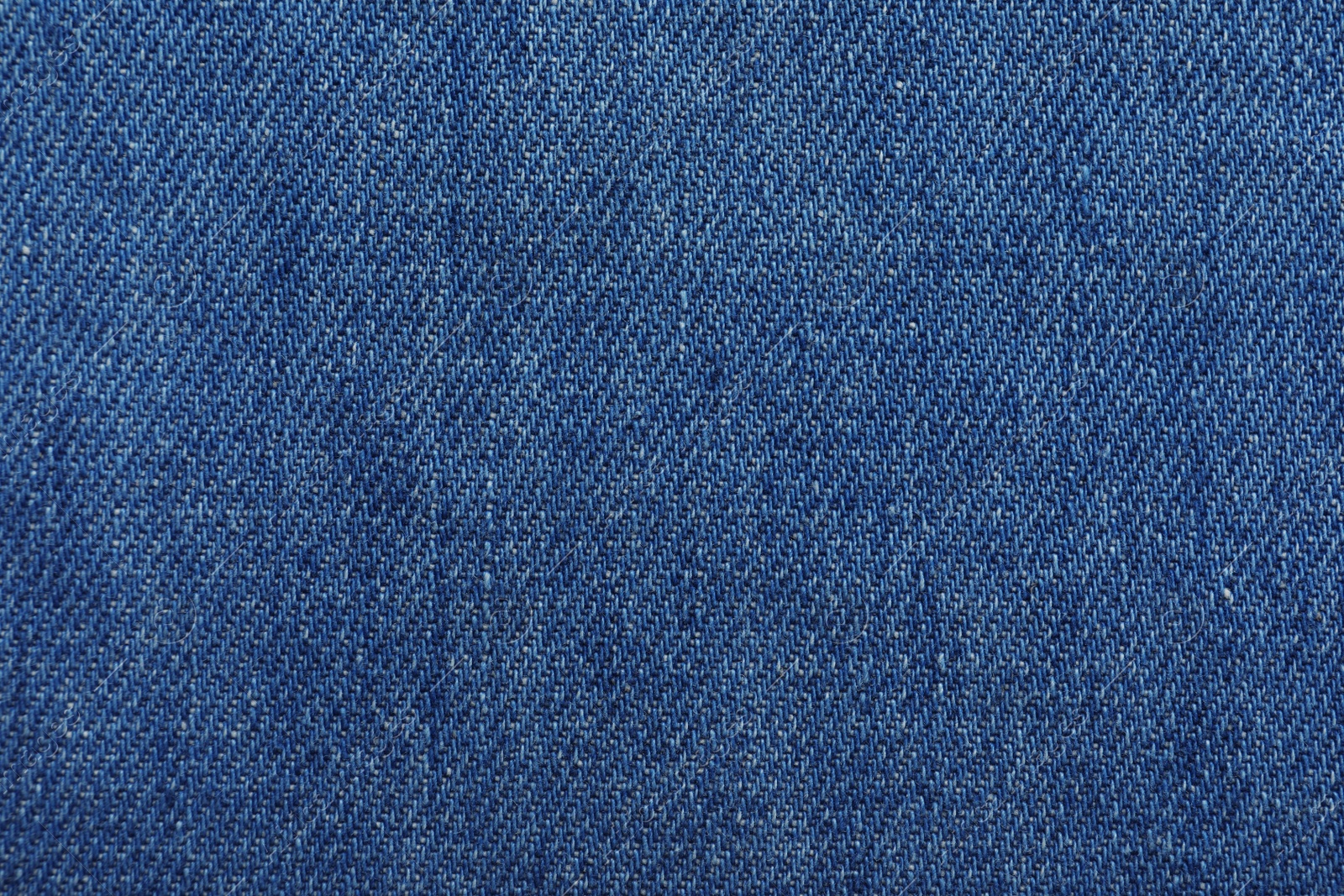 Photo of Texture of blue jeans as background, closeup