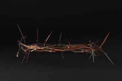 Photo of Crown of thorns on dark background, space for text. Easter attribute