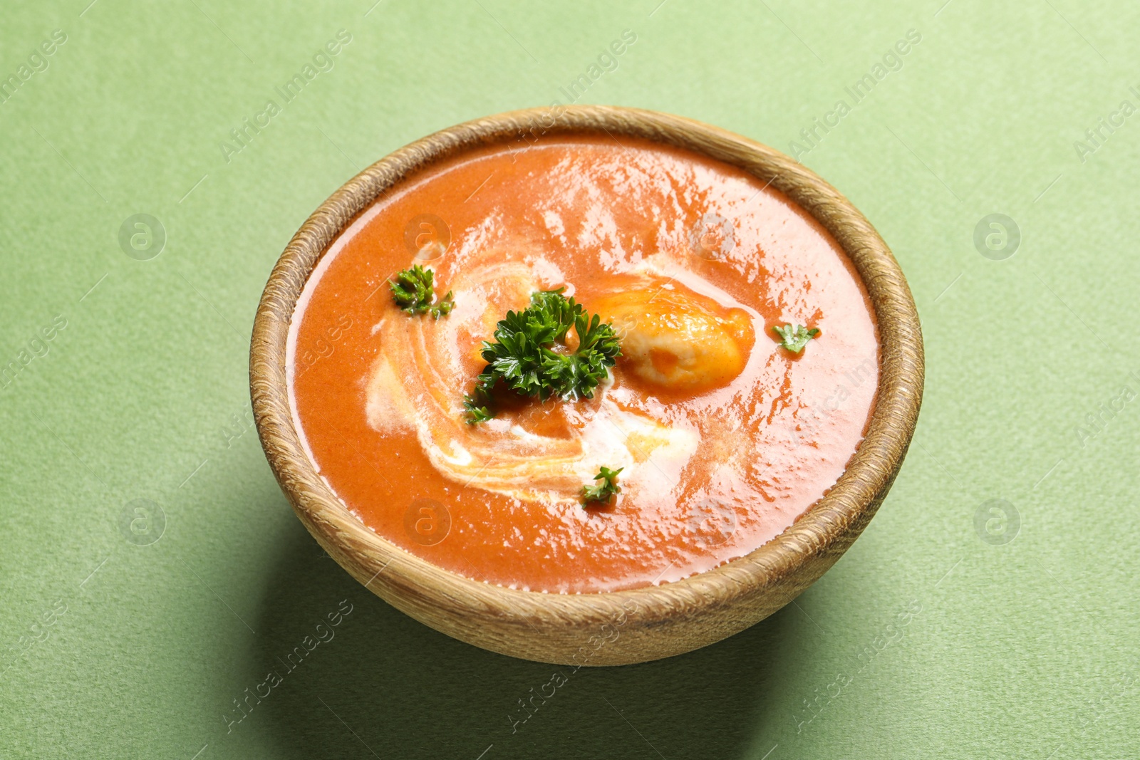 Photo of Bowl of delicious butter chicken on color background. Traditional indian Murgh Makhani