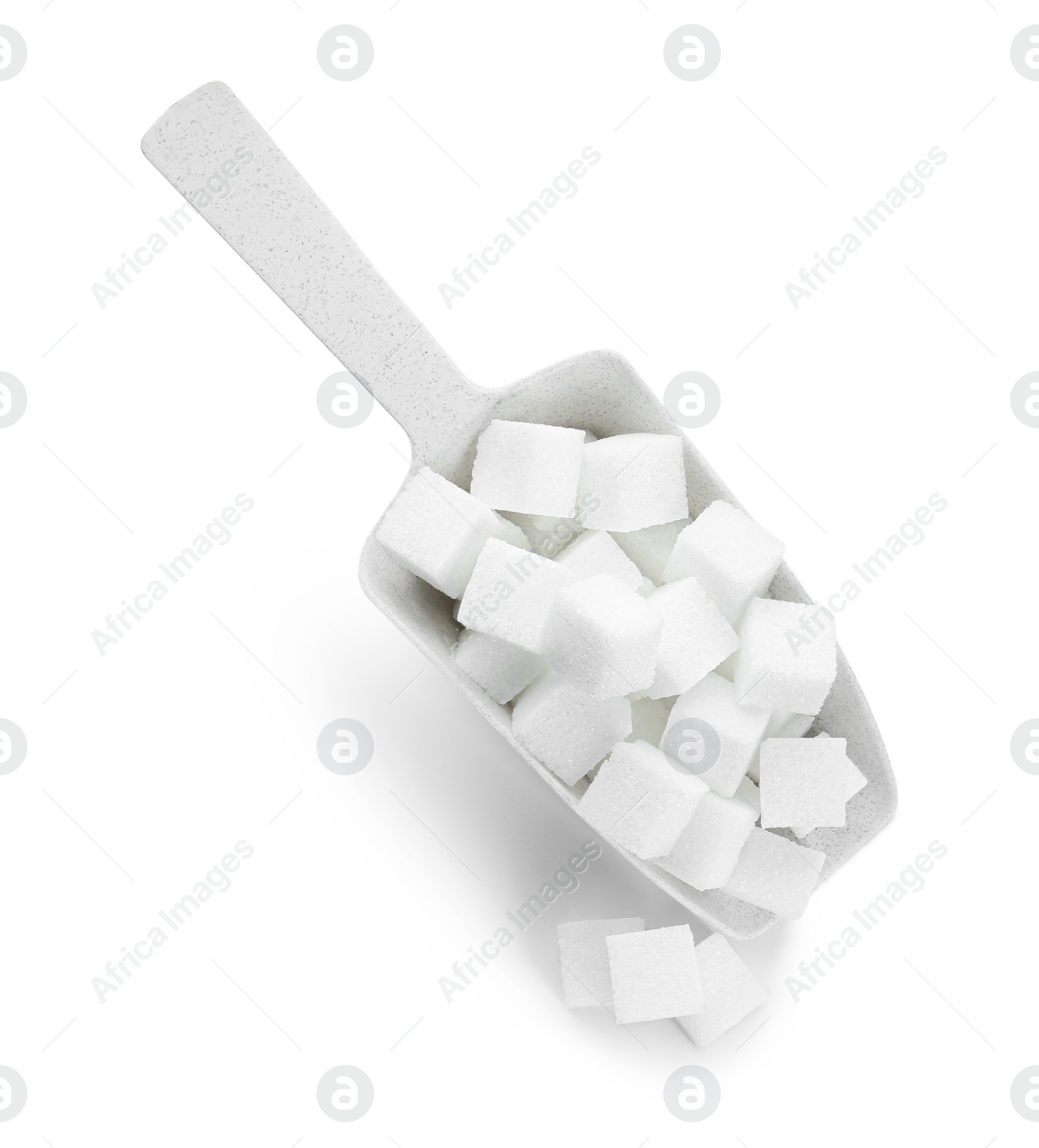 Photo of Sugar cubes in scoop isolated on white, top view