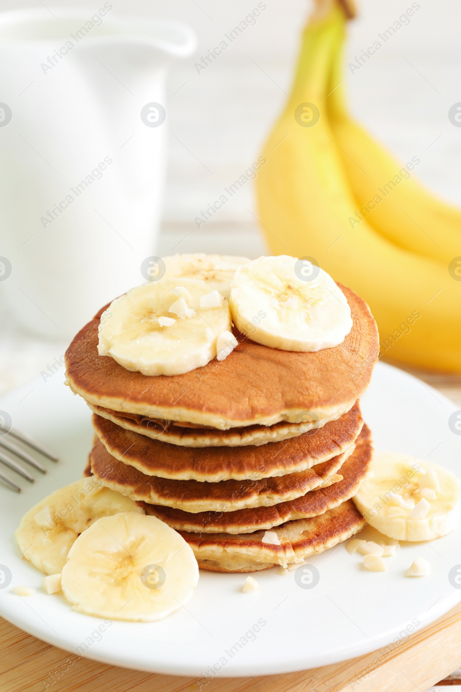 Photo of Plate of banana pancakes on table, closeup