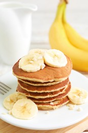 Photo of Plate of banana pancakes on table, closeup