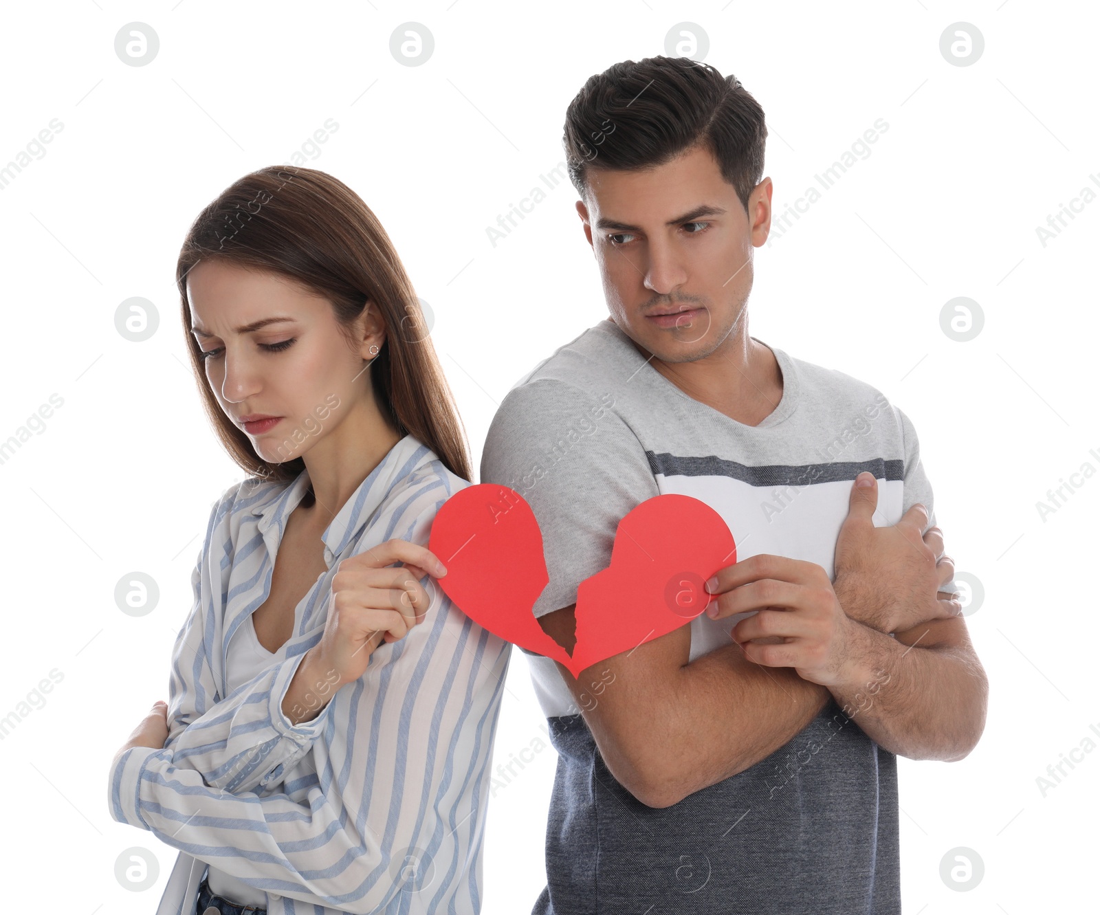 Photo of Couple with torn paper heart on white background. Relationship problems