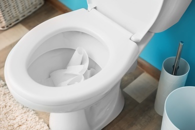 Photo of Crumpled toilet paper inside bowl indoors, above view