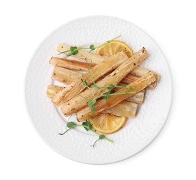 Plate with baked salsify roots and lemon isolated on white, top view