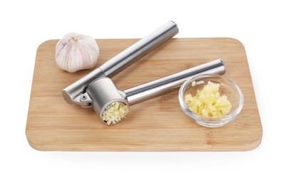 Photo of Board with one metal press and garlic isolated on white