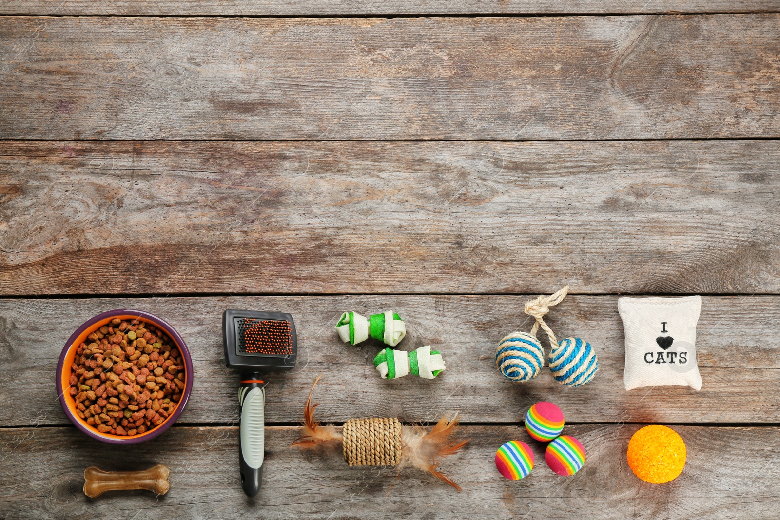 Photo of Flat lay composition with cat accessories and food on wooden background