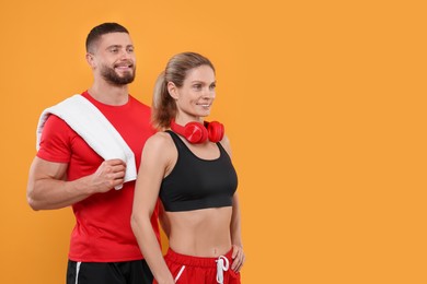 Photo of Athletic people with headphones and towel on yellow background, space for text