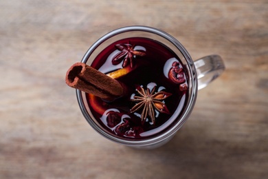 Photo of Delicious red mulled wine on table, top view