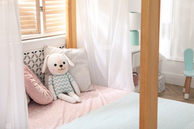 Toy dog on bed in child's room