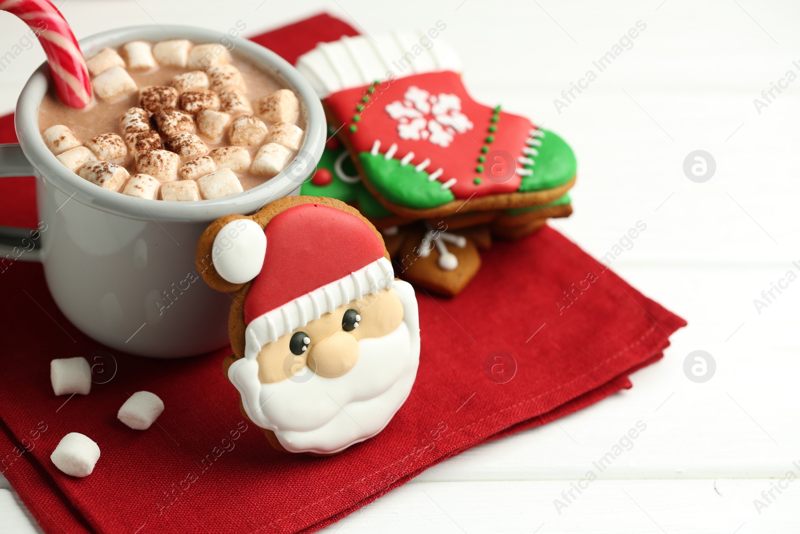 Photo of Tasty homemade Christmas cookies and hot chocolate with marshmallows on white wooden table, closeup. Space for text