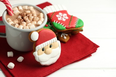 Tasty homemade Christmas cookies and hot chocolate with marshmallows on white wooden table, closeup. Space for text