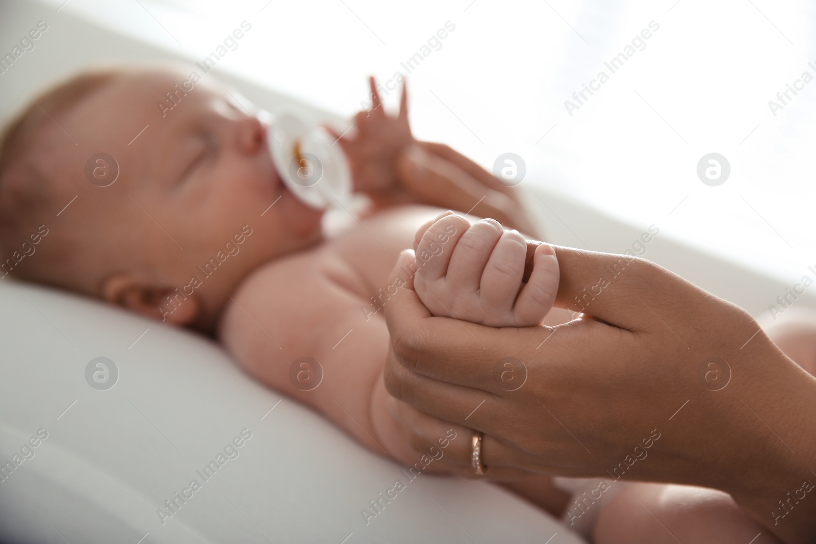 Photo of Mother with her newborn baby, closeup view