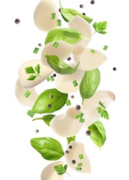 Image of Fresh peeled garlic cloves, peppercorns, basil and parsley flying on white background