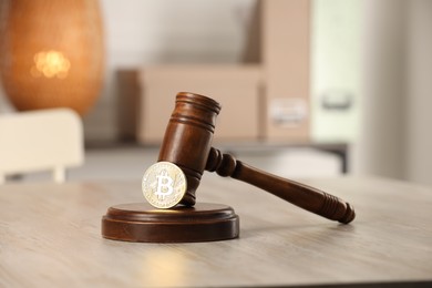 Photo of Law concept. Gavel and bitcoin on wooden table