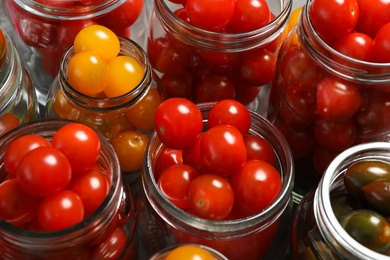 Photo of Pickling jars with fresh tomatoes, closeup view