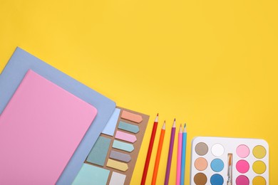 Flat lay composition with different school stationery on yellow background, space for text. Back to school