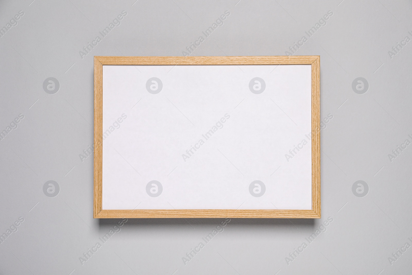 Photo of Empty photo frame on light background, top view. Space for design