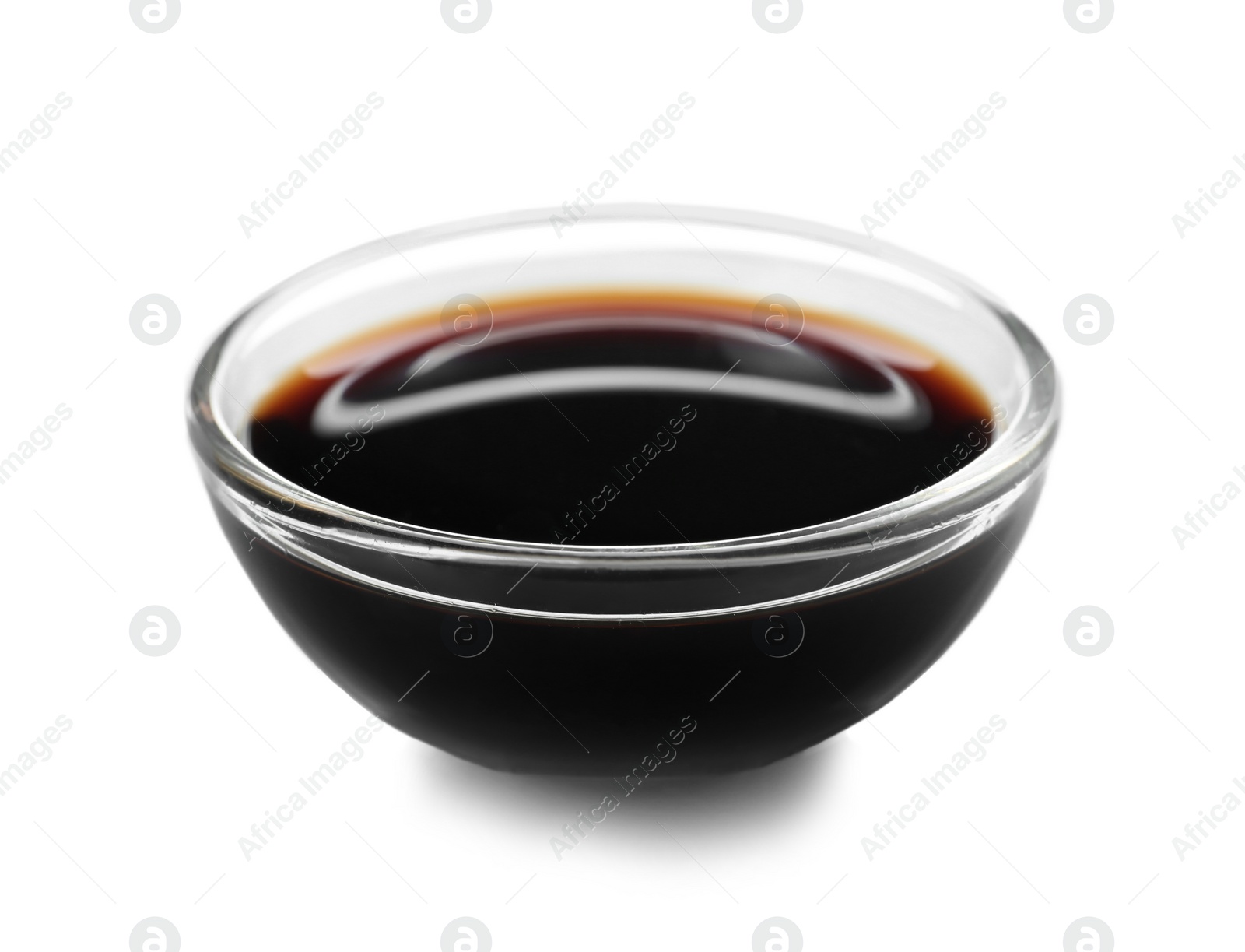 Photo of Bowl of tasty soy sauce isolated on white