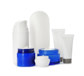 Photo of Different containers with hand cream and other cosmetic on white background