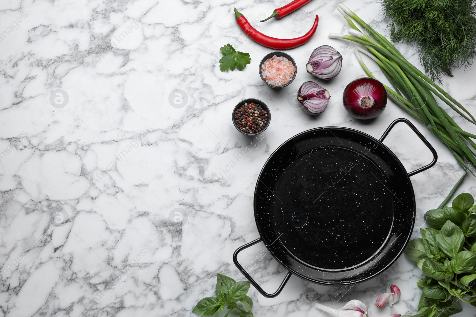 Photo of Flat lay composition with frying pan and fresh products on white marble table, space for text