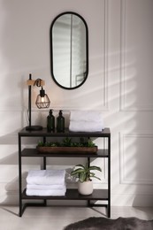 Mirror and shelving in comfortable bathroom. Interior design
