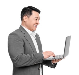 Businessman in suit working on laptop against white background