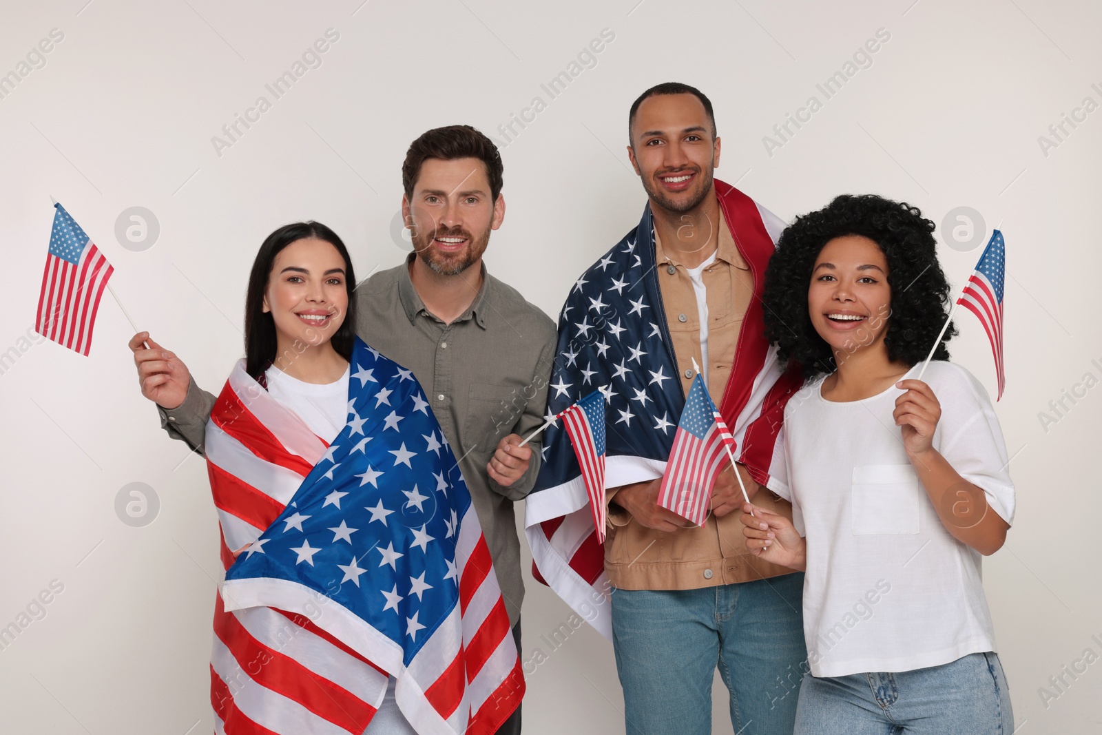 Photo of 4th of July - Independence Day of USA. Happy friends with American flags on white background