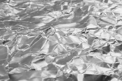 Photo of Crumpled silver foil as background, closeup view