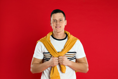 Happy handsome young man on red background