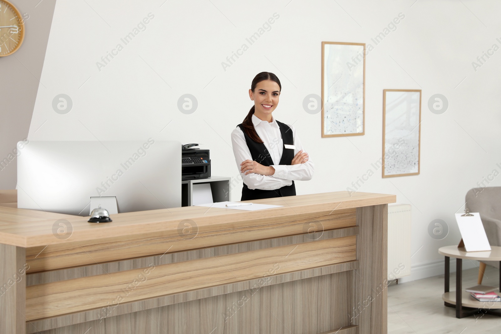 Photo of Portrait of receptionist at desk in modern hotel