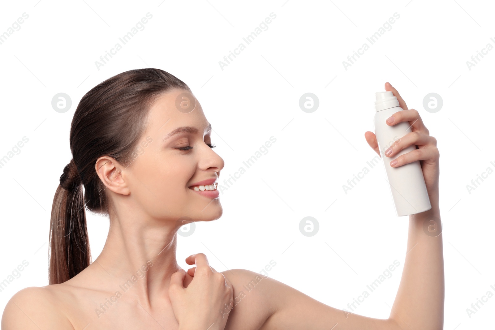 Photo of Young woman applying thermal water on face against white background. Cosmetic product