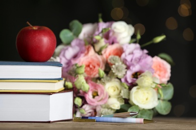 Photo of Composition with flowers and books on wooden table. Teacher's day