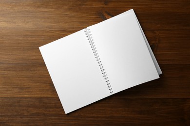 Blank paper brochure on wooden table, top view. Mockup for design