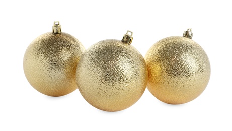 Photo of Beautiful shiny golden Christmas balls on white background