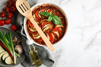 Delicious ratatouille and ingredients on white marble table, flat lay. Space for text