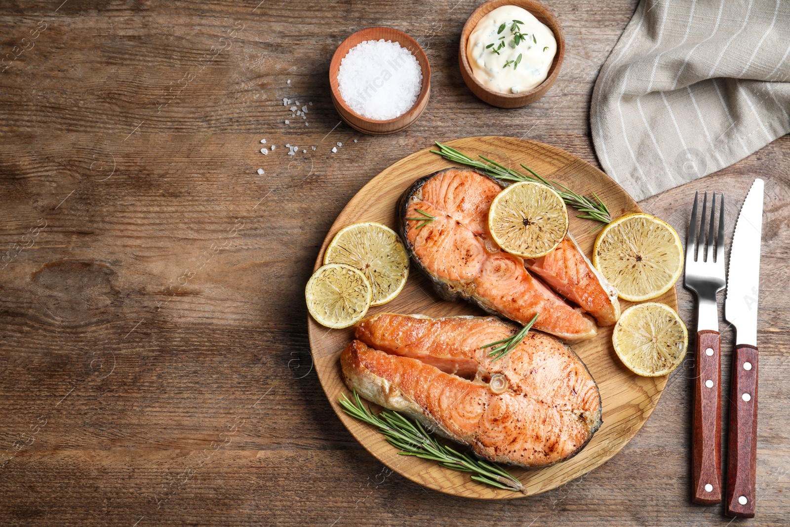 Photo of Flat lay composition with cooked red fish on wooden table, space for text