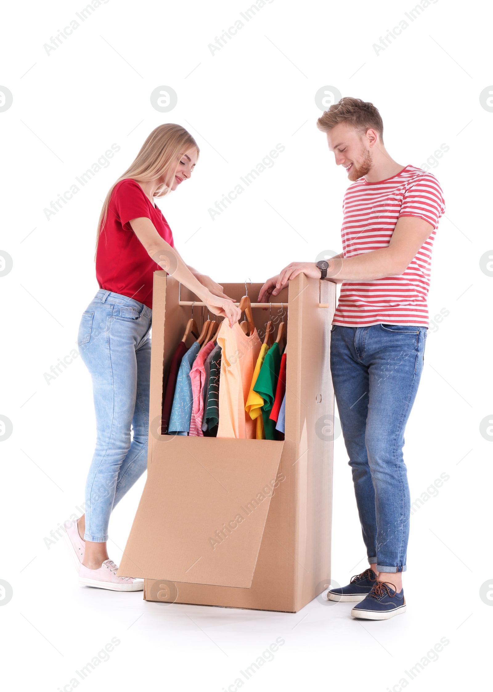 Photo of Young couple near wardrobe box on white background