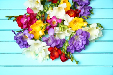 Beautiful freesia flowers on wooden background